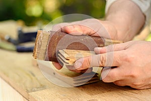 Carpenter hands at work with wood