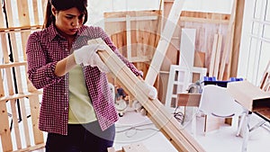 Carpenter holding and comparing size of pieces of boards at site