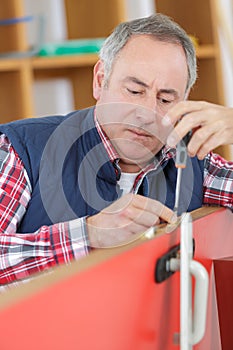 Carpenter installating a doorlock photo