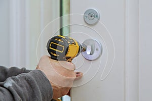 Carpenter installation at interior wood door lock