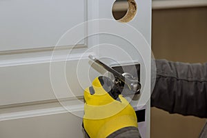 Carpenter installation at interior wood door lock