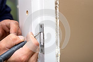 Carpenter installation the lock into the door
