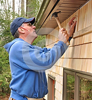 Carpenter installing cedar shingles