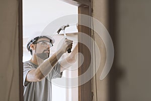 Carpenter installing a door jamb at home