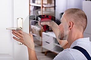 Carpenter Installing Door Lock