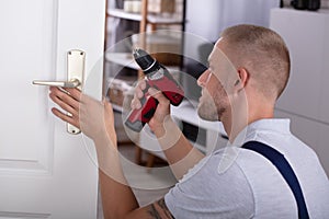 Carpenter Installing Door Lock