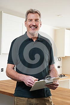 Carpenter Installing Luxury Fitted Kitchen