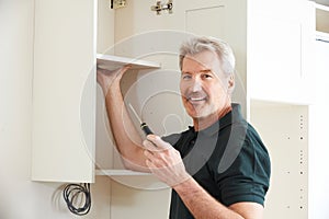 Carpenter Installing Luxury Fitted Kitchen