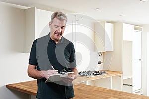 Carpenter Installing Luxury Fitted Kitchen