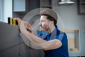 Carpenter Installing Luxury Modern Fitted Kitchen