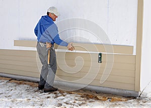 Carpenter installing siding photo