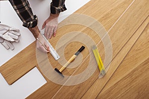 Carpenter installing a wooden flooring photo