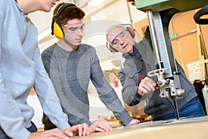 Carpenter instructor with students in workshop