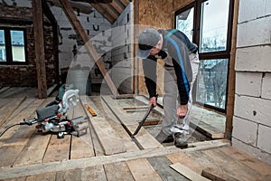 Carpenter lays a wooden floor