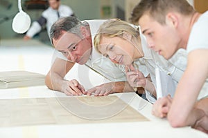 Carpenter learning during measuring apprenticeships lesson photo