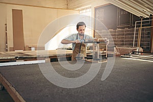 Carpenter making a display case in his workshop