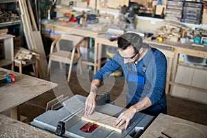 Carpenter Making Furniture in Shop