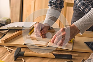 Carpenter making picture frame in workshop