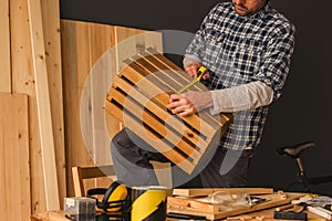 Carpenter making wooden crate in small business woodwork workshop