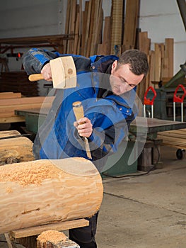 Carpenter with mallet and chisel