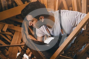 Carpenter man attend to making masterpiece woodworks handcrafted fine detail make wooden furniture in wood workshop