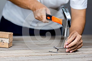 Carpenter man hammering a nail