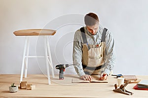 Carpenter man making draft plan using pencil on the table with tools