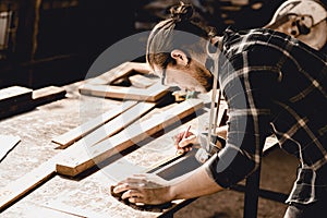 Carpenter man making masterpiece woodworks handcraft furniture in wood workshop