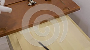 Carpenter man measuring raw board for his carpentry project.