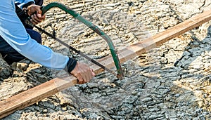 Carpenter man use saw cut wooden plank build house