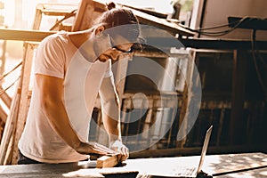 Carpenter man woodcraft working in furniture wood workshop with professional skill real people workman photo