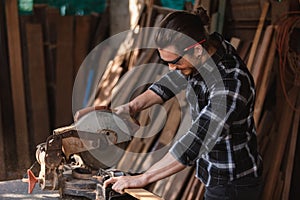 Carpenter man working use electric saw cutting wood.