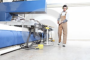 Carpenter man works with wooden planks in the joinery, with computer numerical control center, cnc machine,  isolated on a white