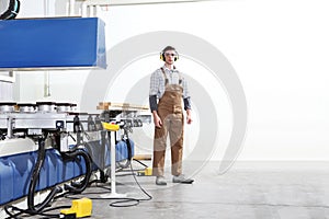 Carpenter man works with wooden planks in the joinery, with computer numerical control center, cnc machine,  isolated on a white