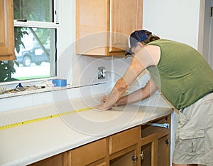 Carpenter Measures Counter Top