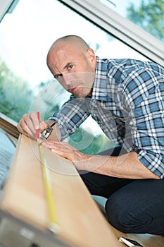 carpenter measuring plank