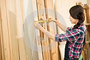 Carpenter measuring suitable wood