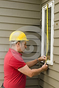 Carpenter measuring window repair