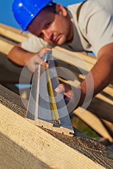 Carpenter measuring wood planck photo