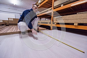 Carpenter measuring wooden board