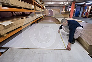 Carpenter measuring wooden board