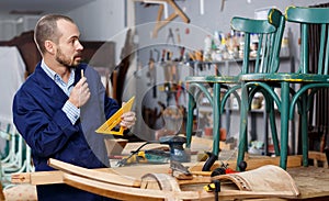 Carpenter measuring wooden plank