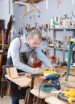 Carpenter measuring wooden plank