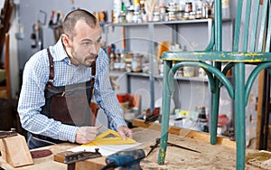 Carpenter measuring wooden plank