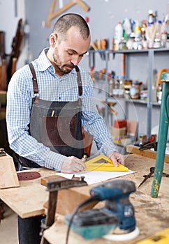 Carpenter measuring wooden plank