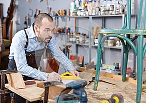 Carpenter measuring wooden plank