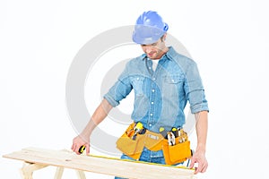 Carpenter measuring wooden plank