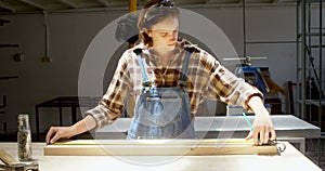 Carpenter measuring wooden plank in workshop 4k