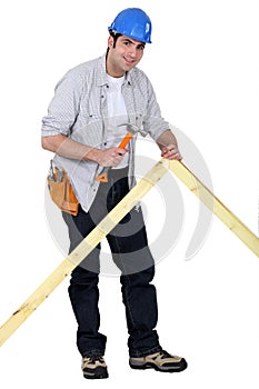 Carpenter nailing a frame