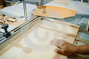 Carpenter at pc works with woodworking machine